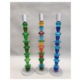 Three art glass and aluminum candlesticks