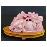 Pink carved jade dragon figure on a wood stand