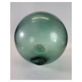 Vintage green glass fishing float with makers mark