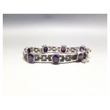 Sterling silver, marcasite, and purple crystal