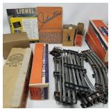 Group of vintage Lionel train tracks and carts