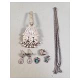 Group of silver costume jewelry scratch tested