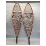 Vintage wood snow shoes with rawhide webbing