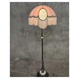 Victorian style brass floor lamp on a marble and