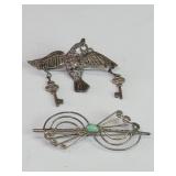 Pair of silver brooches