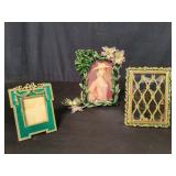 Three metal and enamel picture frames