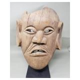 Vintage carved wood mask with metal display stand