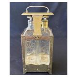 Vintage brass double Tantalus glass decanters