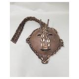 Vintage iron mask with Cowrie shells on leather