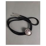 Silver top bolo tie on leather