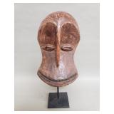 Vintage African carved wood mask on iron stand