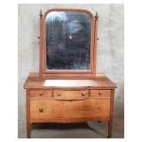 Antique tiger oak dresser on casters with mirror