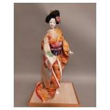 Vintage Japanese geisha doll on wood stand