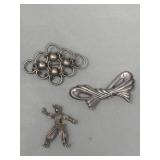 Pair of sterling silver brooches with silver