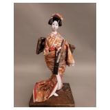 Vintage Japanese geisha doll on wood stand