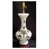 Vintage milk glass table with metal motifs