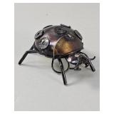Handcrafted scrap metal ladybug sculpture from