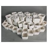 A set of vintage white ceramic milk jugs from a