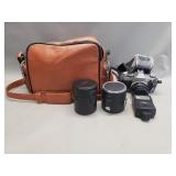 Canon A-E1 film camera with bag and accessories