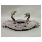 Vintage brass candleholder depicting a pair of
