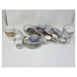 Group of porcelain teacup, plates, saucers, and