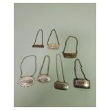 Seven sterling silver bottle tags