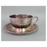 Silver cup and saucer