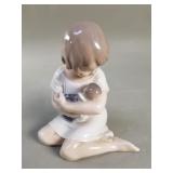 Royal Copenhagen girl holding doll figurine