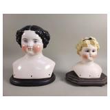 Pair of vintage porcelain doll heads and wood