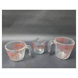 Three vintage glass measuring cups