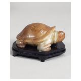 Carved jadeite turtle sculpture with carved wood
