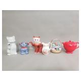 Group of porcelain and ceramic teapots, cream a
