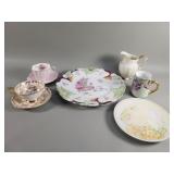 Group of porcelain teacups, saucers, pitcher,