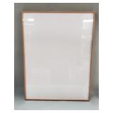 Blank canvas Jerry Solomon frame behind glass