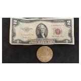 1923 Peace silver dollar coin and a 1953 Red
