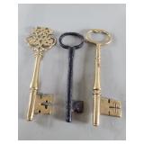 Two vintage brass and one antique iron skeleton