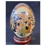 Large hand-painted ceramic egg with stand