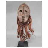 Lega beaded carved wood mask rubbed with clay