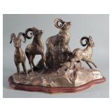 Brass rams sculpture on wood base