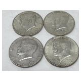 Four 1964 silver Kennedy half dollar coins