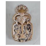 Vintage brass clip depicting a mythological face