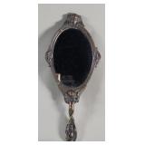 Vintage bronze hand held mirror depicting cherubs