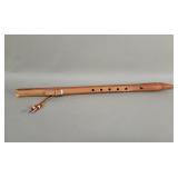 Native American style wood flute depicting a