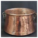 Vintage hand-hammered copper cauldron with iron