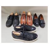 Group of men's leather footwear with shoe trees