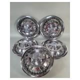 Five vintage Chevrolet hubcaps