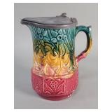 Majolica style ceramic pitcher with hinged lead