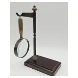Vintage-style brass magnifying glass on wood and