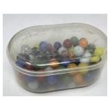 Vintage marbles in plastic container