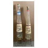 2 large empty Galliano bottles with stand